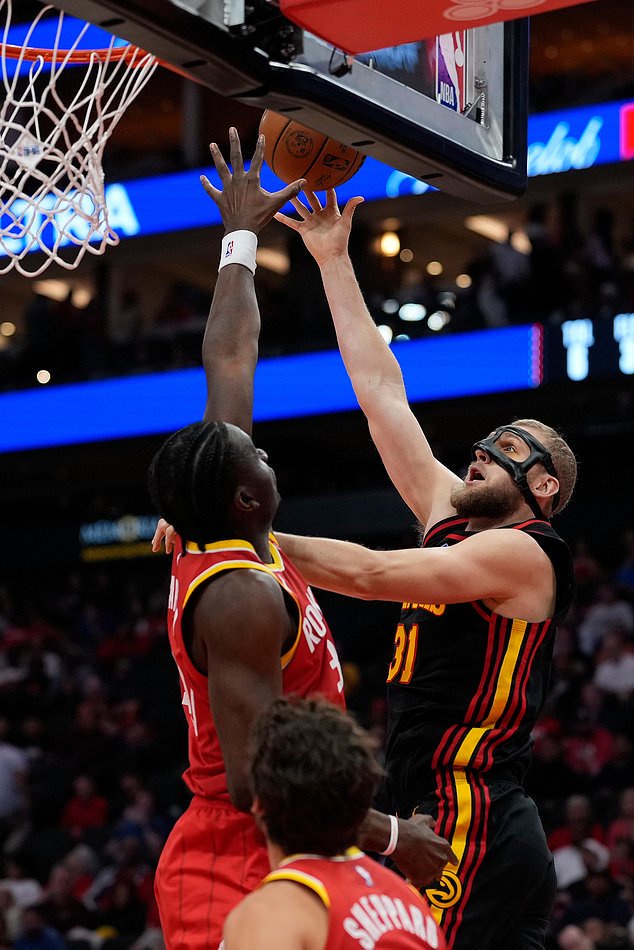 Atlanta Hawks center Jock Landale, top right, is defended by Houston Rockets center Clint Capelam, top left, during the first quarter of an NBA basketball game Monday, Oct. 26, 2026, in Houston. (AP Photo/Kevin M. Cox)