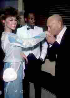 Murphy seen gasping as Yul Brynner kissed the hand of American singer and Miss America Vanessa L. Williams in 1984 (Oscar Abolafia/TPLP/Getty Images)