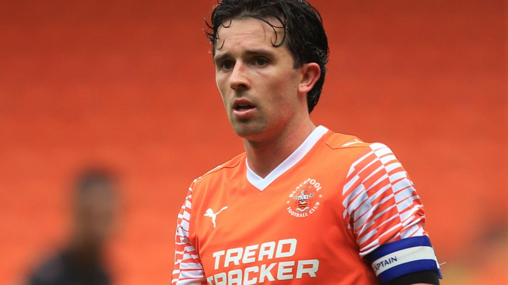 George Honeyman in an orange home Blackpool shirt
