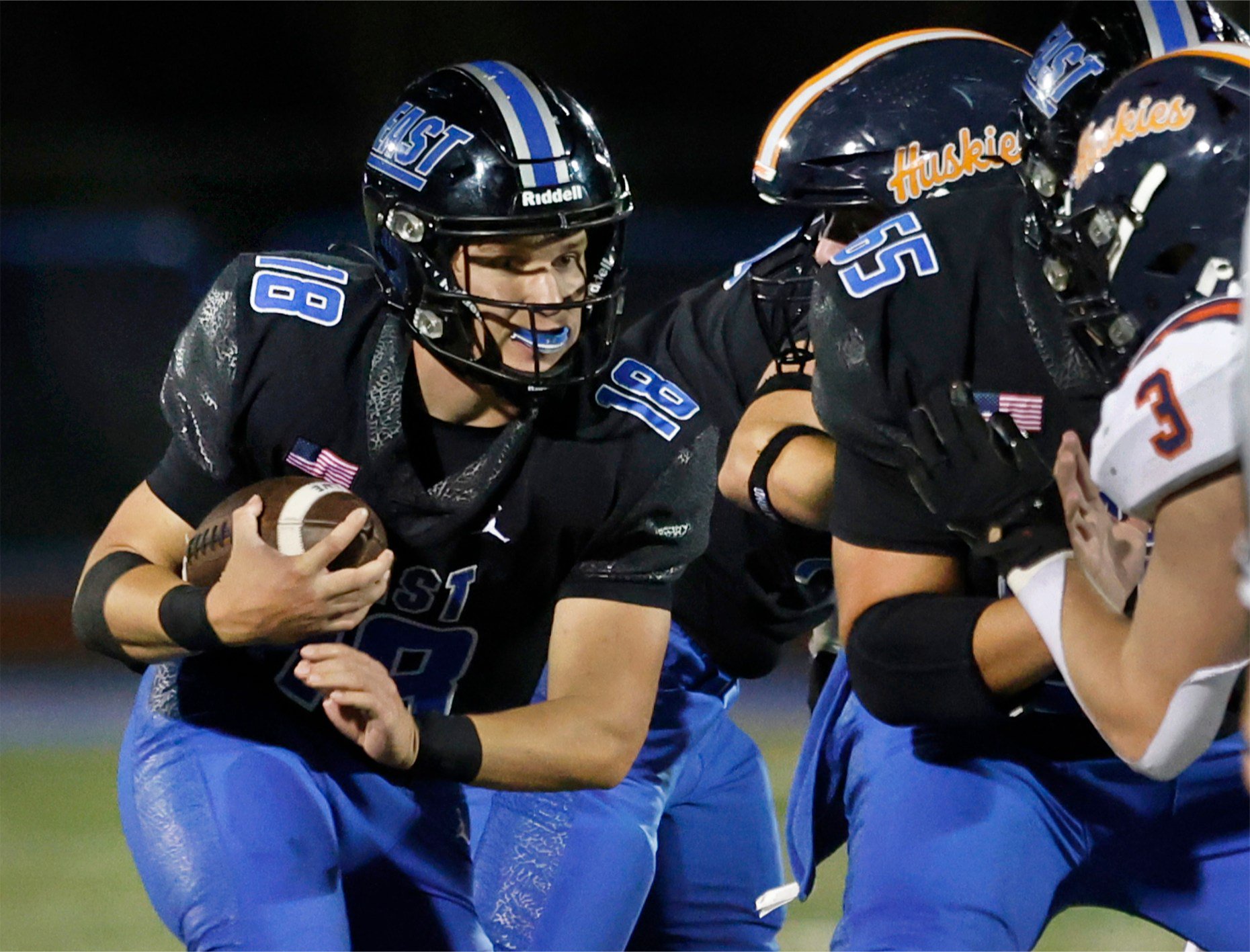 Lincoln-Way Eastâs quarterback Tyler Spychalski (18) keeps the ball as...