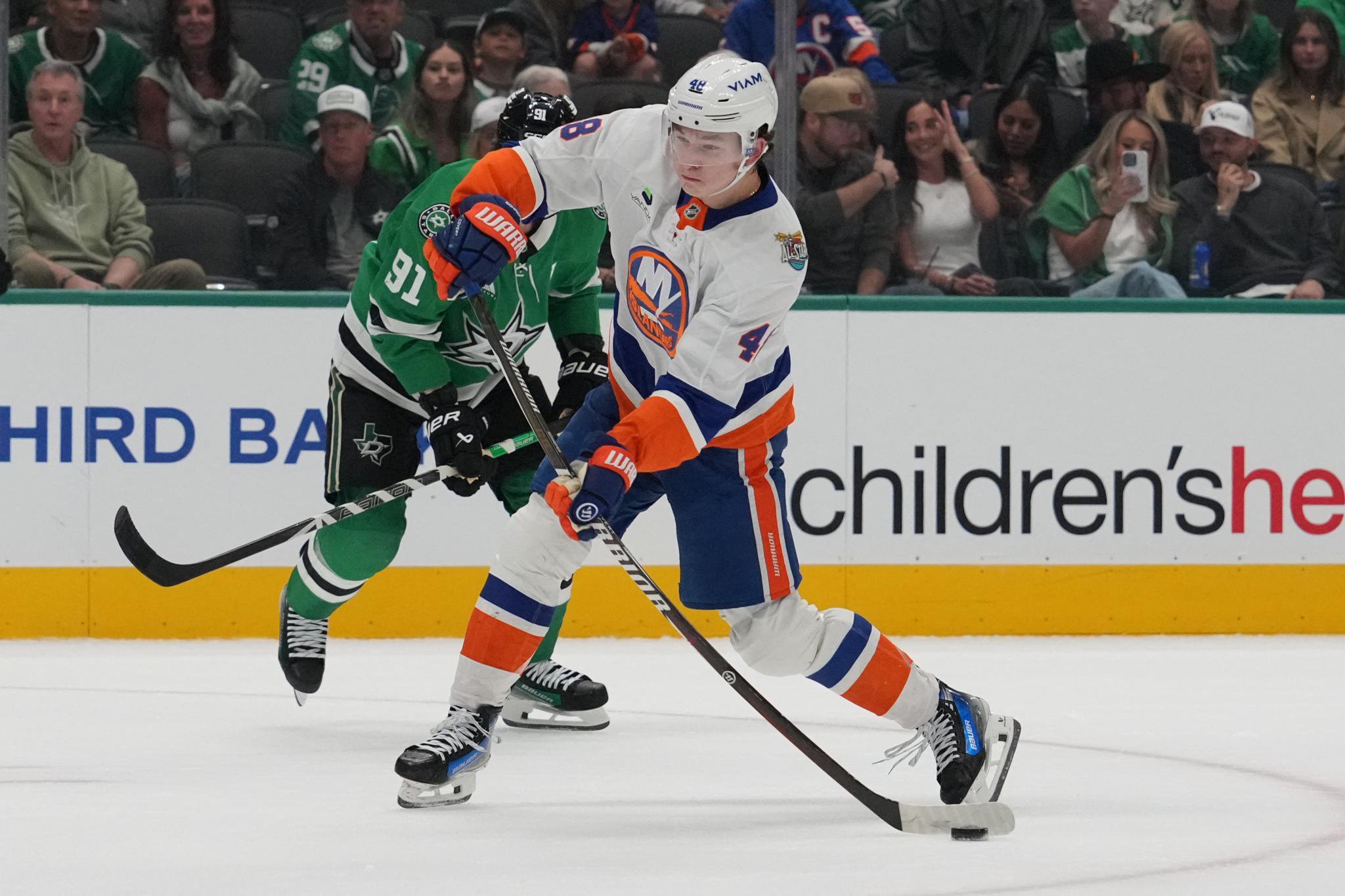 New York Islanders defenseman Matthew Schaefer shoots the puck against the Dallas Stars during an NHL hockey game.