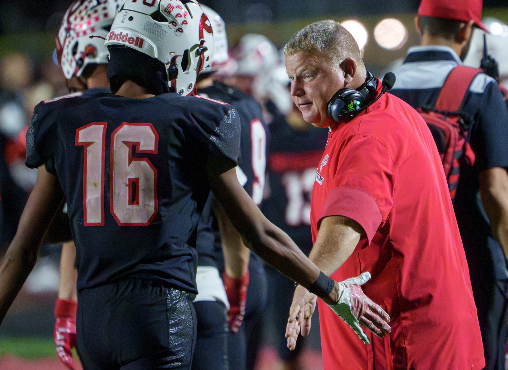 Pekin head coach Doug Nutter encourages his players after a Morton touchdown in the second half of their Week 8 high school football game Friday, Oct. 9, 2026 in Pekin. The Potters defeated the Dragons 42-13.