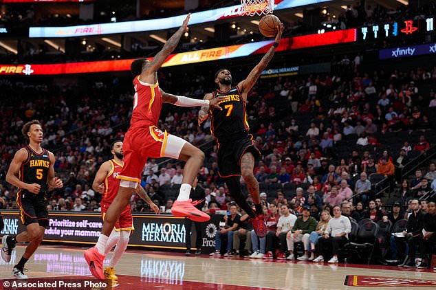 Atlanta Hawks guard Nickeil Alexander-Walker (7) is defended byHouston Rockets forward Jabari Smith Jr., front left, during the first quarter of an NBA basketball game Monday, Oct. 26, 2026, in Houston. (AP Photo/Kevin M. Cox)