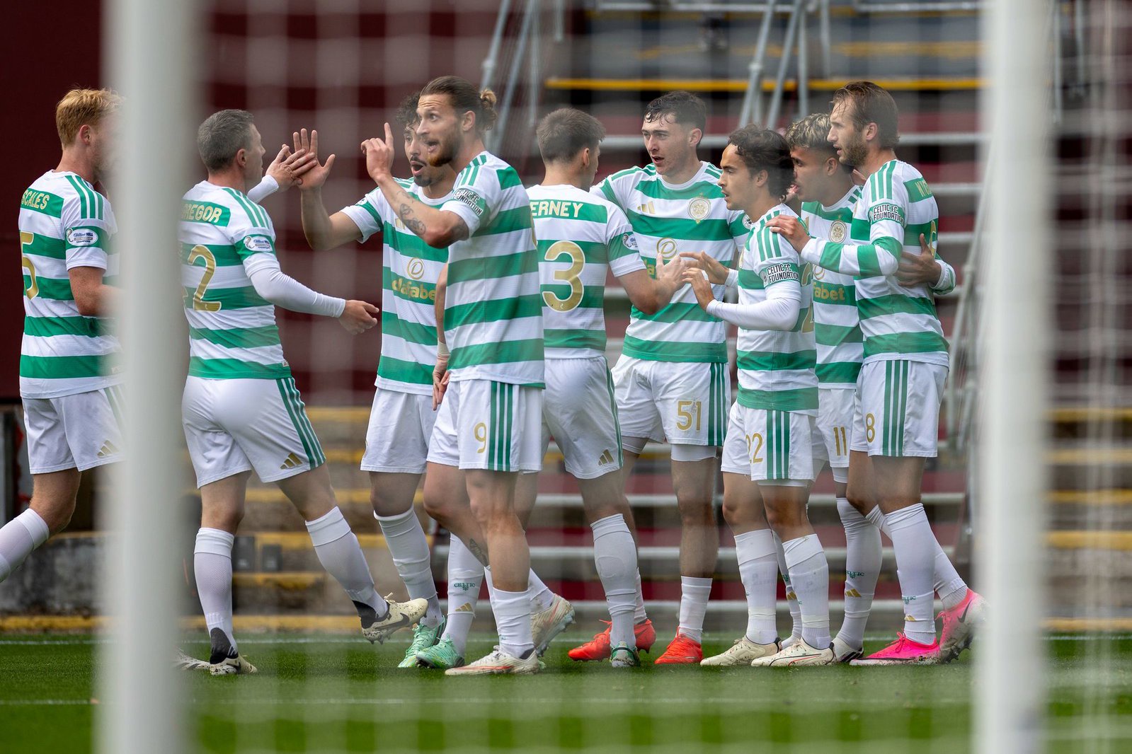 Celtic players celebrate the opening goal at Fir Park