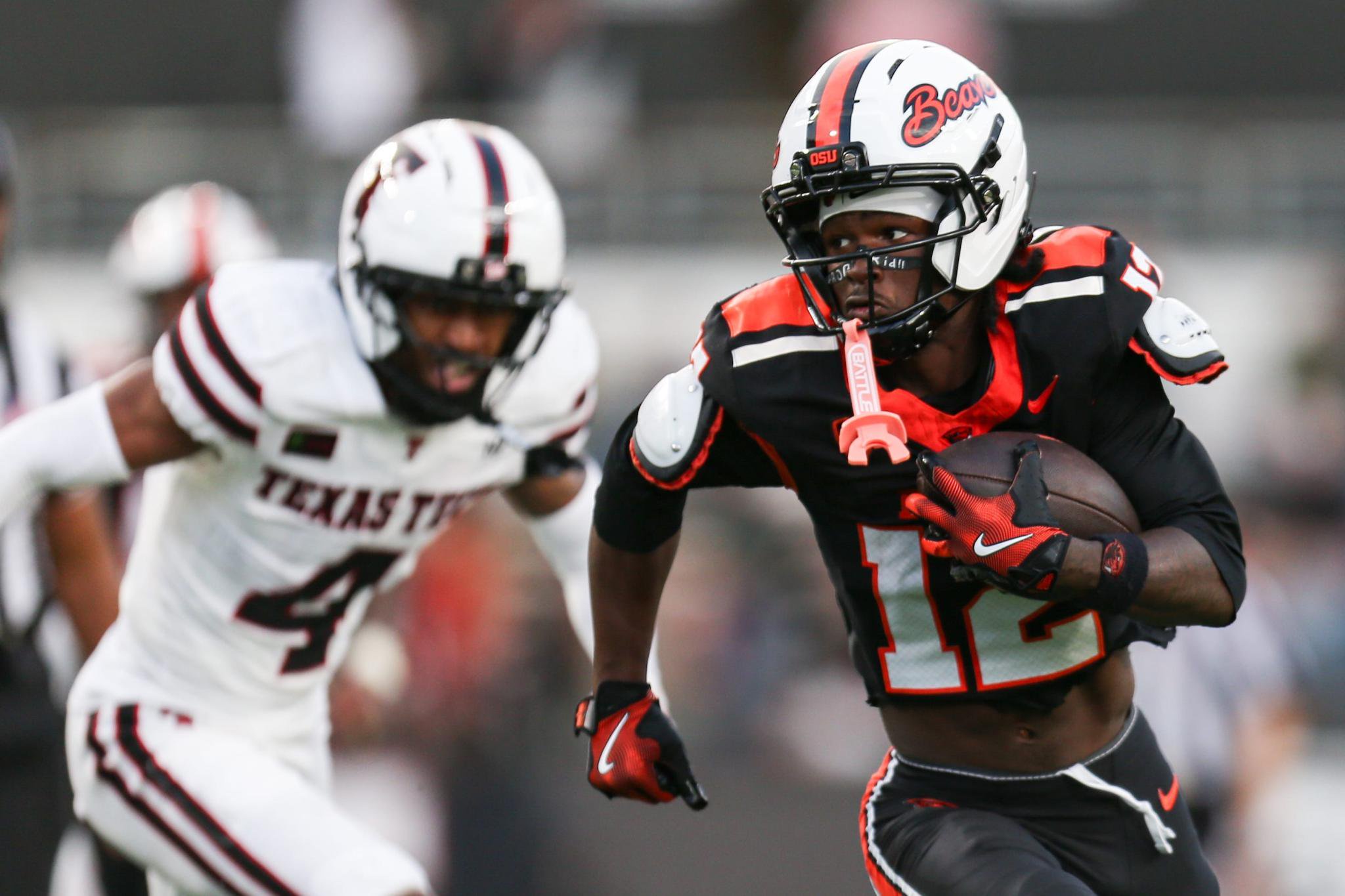 Oregon State's Jesse Legree runs the ball into the end zone for a touchdown during a football game.