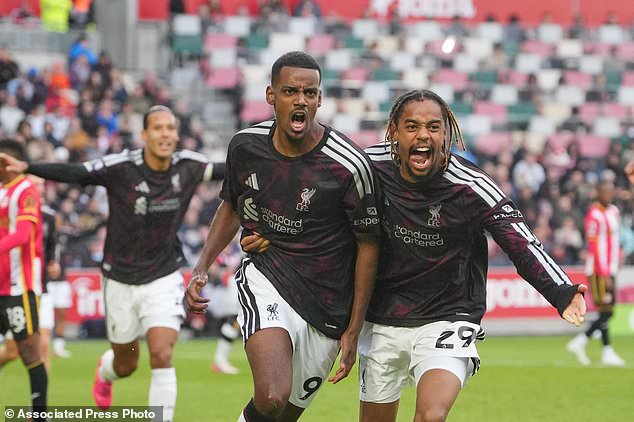 Liverpool's Alexander Isak, left, and Liverpool's Bradley Barcola celebrate after scoring during the English Premier League soccer match between Brentford and Liverpool in London, Saturday, Oct. 17, 2026. (AP Photo/Kin Cheung)