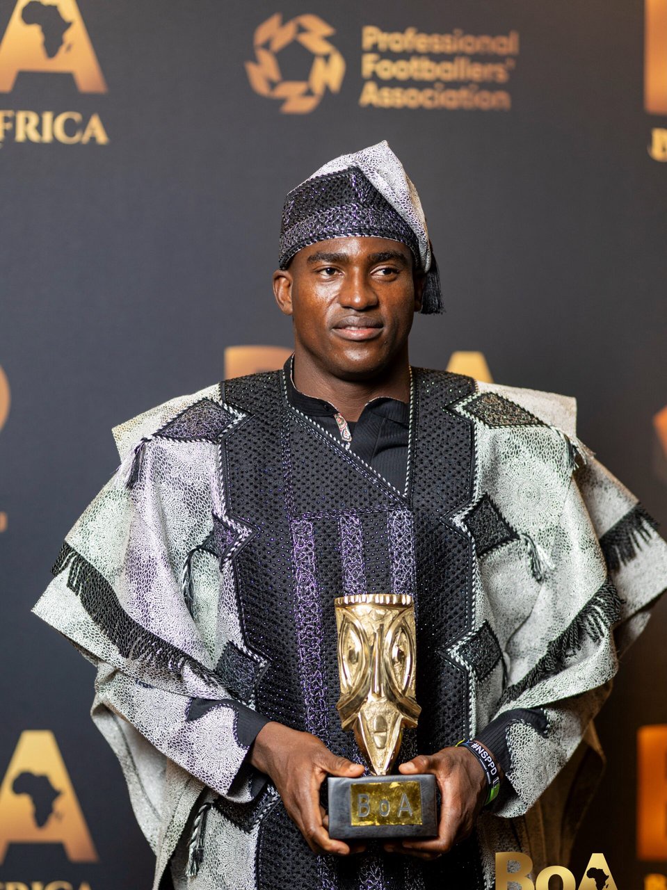 Taiwo Awoniyi holding the PFA Beyond the Pitch Award trophy in traditional Agbada and Fila at the 2026 Best of Africa Awards in London