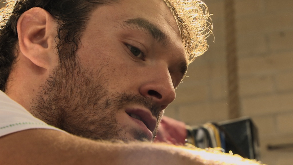 Close-up of Tyson Fury with a serious expression in an indoor setting.