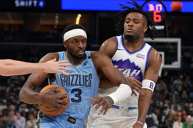 Memphis Grizzlies forward Jerami Grant (3) drives against Utah Jazz guard Isaiah Collier (8) in the second half of an NBA basketball game Wednesday, Oct. 21, 2026, in Memphis, Tenn. (AP Photo/Brandon Dill)