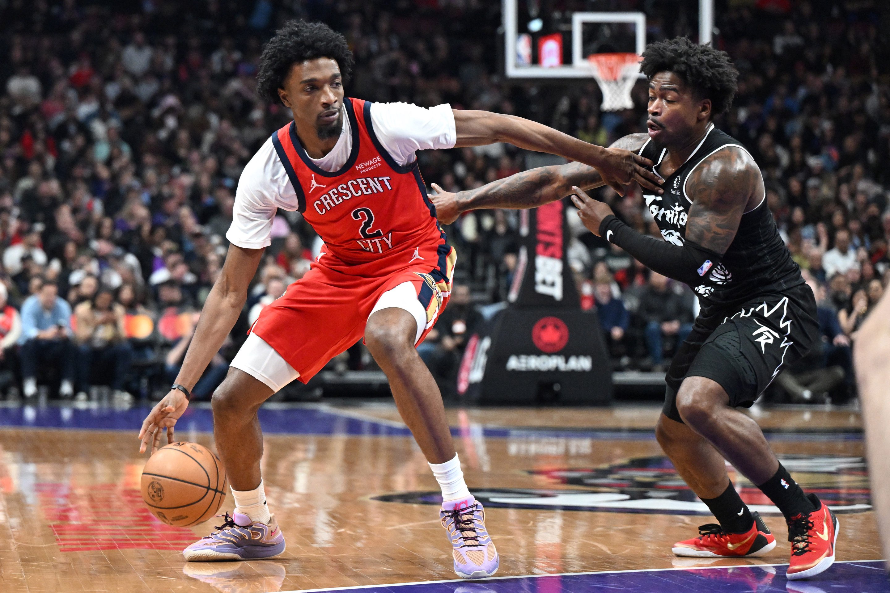 Mar 27, 2026; Toronto, Ontario, CAN;  New Orleans Pelicans forward Herb Jones (2) dribbles against Toronto Raptors guard Jamal Shead (23) in the first half at Scotiabank Arena. Mandatory Credit: Dan Hamilton-Imagn Images