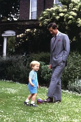 King Charles playing football with young Prince William
