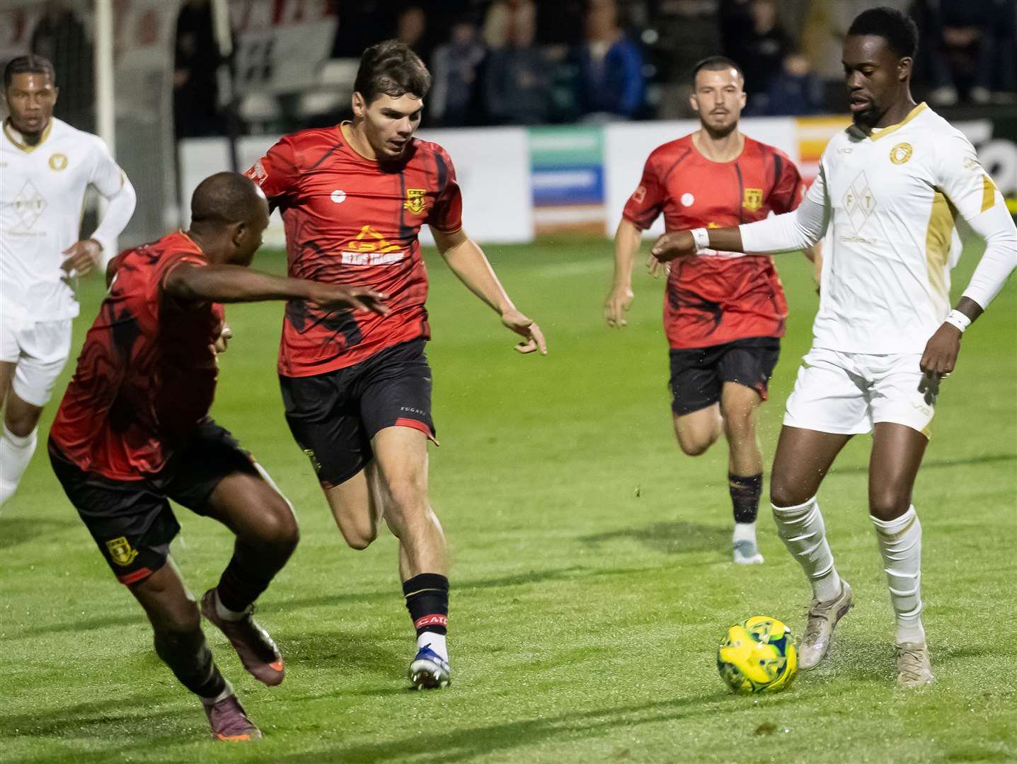 Kenny Aileru, of Whitstable Town, races with Sittingbourne’s ex-Whitstable striker Harvey Smith chasing at Woodstock. Picture: Les Biggs