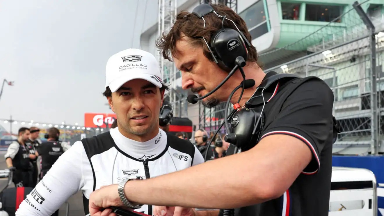 Sergio Perez finishing up last minute preparations on the grid