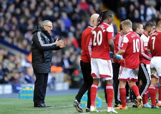 Felix Magath (left) manager of Fulham talks to his players during a break in play during the Barclays Premier League match between West Bromwich Albion and Fulham at the Hawthorns on February 22, 2014 in West Bromwich, England.