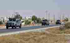 Illustrative: Jordanian security vehicles patrol the area surrounding the site of an explosion at a military munitions depot in the city of Zarqa,  east of the capital Amman, September 11, 2020. (Khalil Mazraawi/AFP)