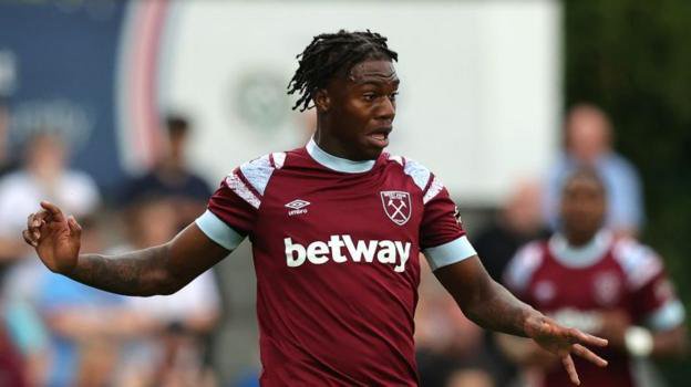 Thierry Nevers running on a football pitch. He is wearing a West Ham football kit, which is burgundy with light blue and white features. "betway" is printed in which writing below his chest. There is an umbro logo and a West Ham logo on his shirt. The background is blurred.