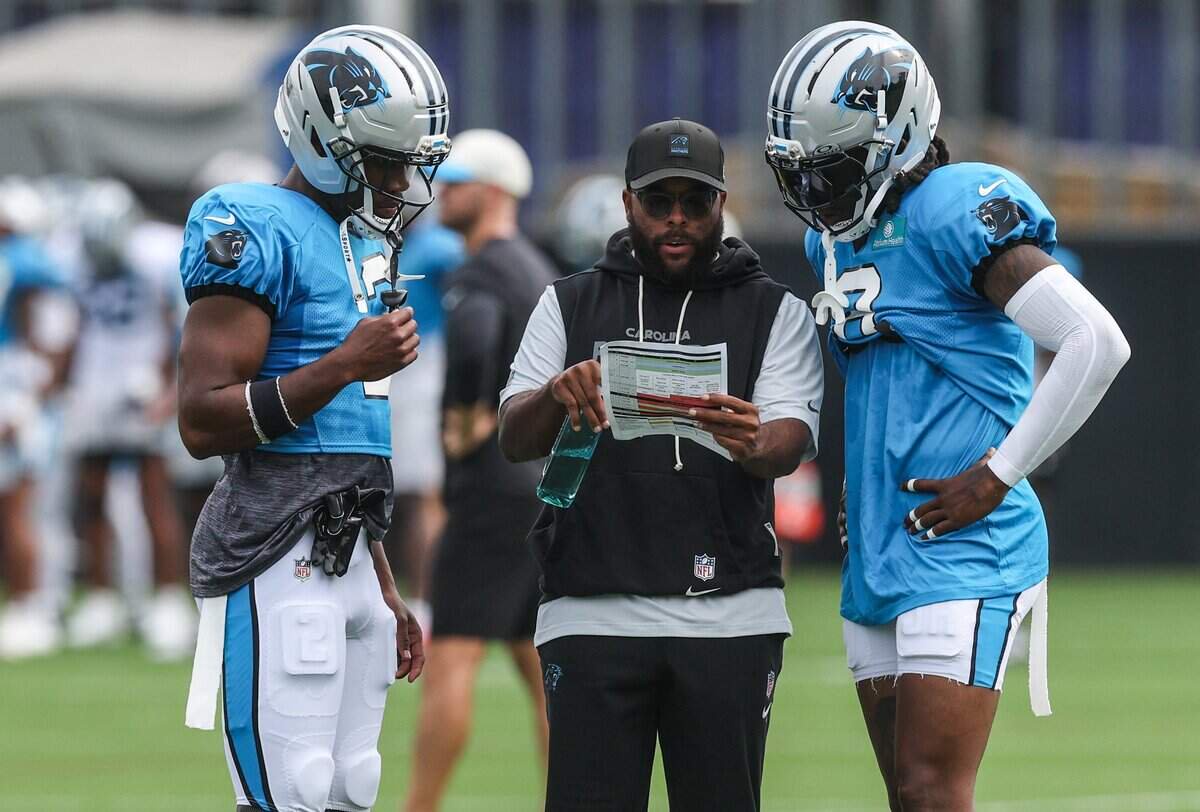 Panthers defensive passing game coordinator, James Cooley, center, talks to cornerbacks Mike Jackson, left, and Jaycee Horn during training camp practice on Tuesday, July 28, 2026.