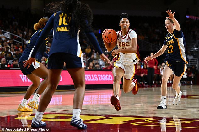 Southern California guard Juju Watkins, second from right, drives with the ball during the first half of an NCAA college basketball exhibition game against California, Sunday, Oct. 25, 2026, in Los Angeles. (AP Photo/William Liang)
