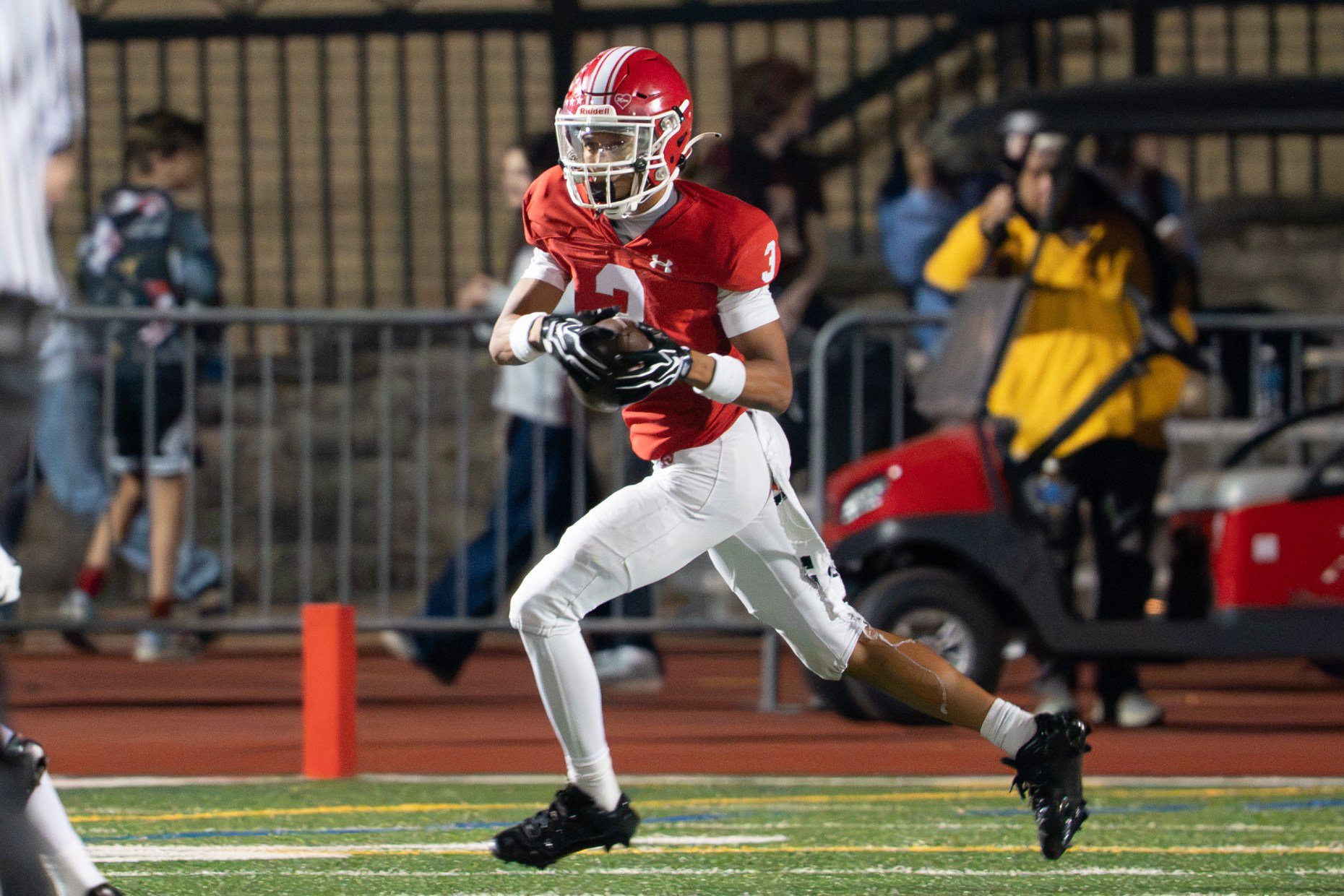 Naperville Central's Mark Williams (3) runs after the catch against...