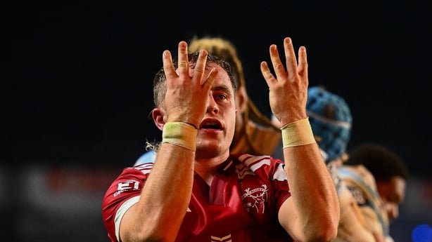 Craig Casey of Munster celebrates after scoring his side's fifth try v Racing 92 with acknowledgement to Anthony 'Axel' Foley by looking holding up 8 fingers