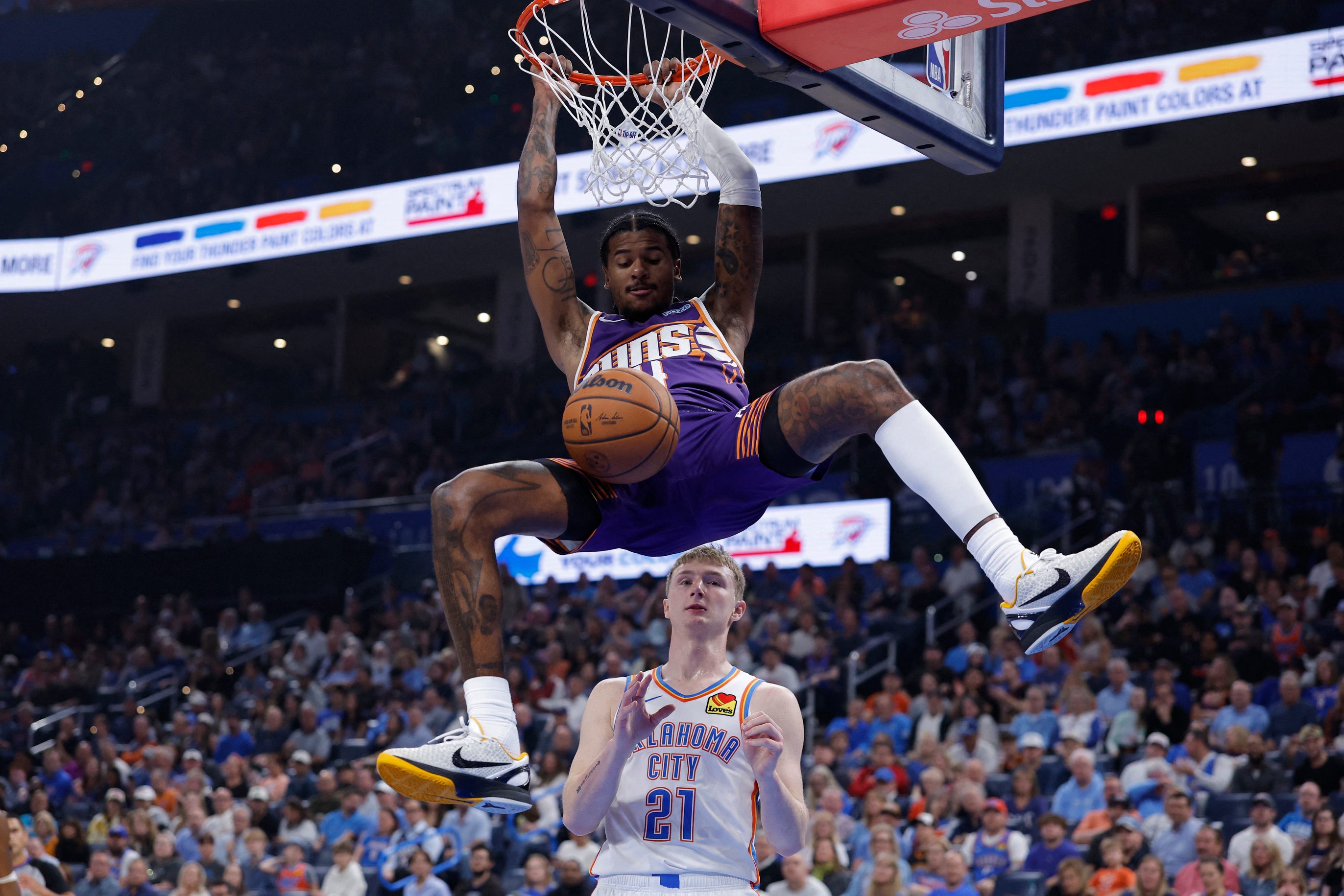Oct 26, 2026; Oklahoma City, Oklahoma, USA; Phoenix Suns guard Jalen Green (4) dunks in front of Oklahoma City Thunder guard Josh Dix (21) during the first half at Paycom Center. Mandatory Credit: Alonzo Adams-Imagn Images