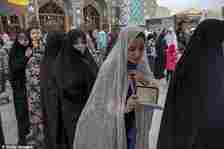 Iranian women line up to vote for the presidential election at a polling station at the shrine of Saint Saleh in northern Tehran