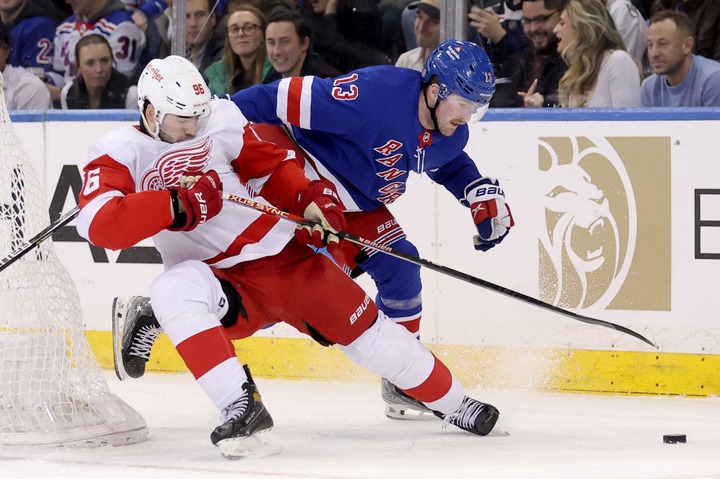 Alexis Lafreniere battles Jake Walman (left) for the puck during the Rangers' win over the Red Wings.