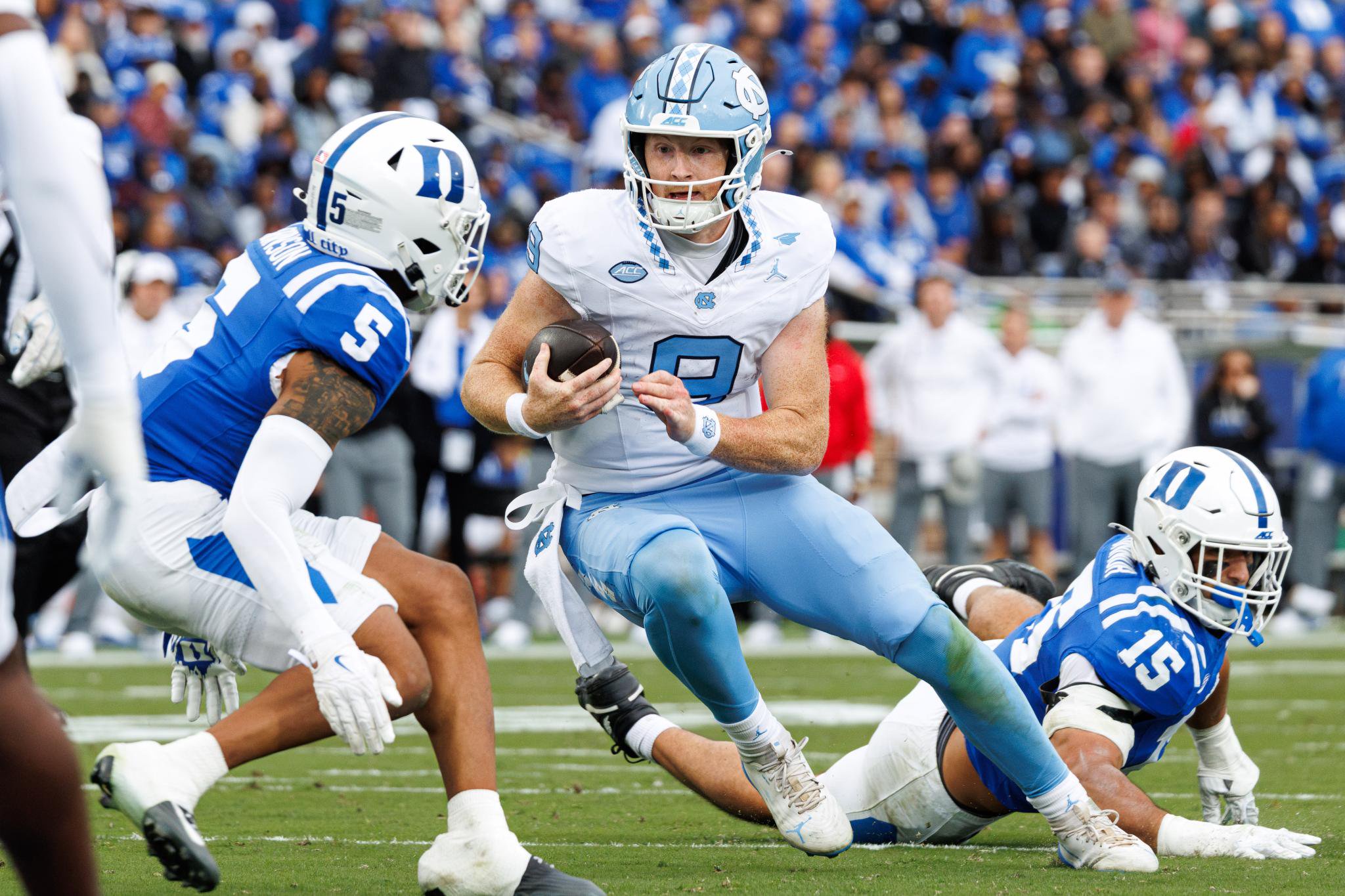 North Carolina's Billy Edwards Jr. carries the ball as Duke's Kevin O'Connor and Kimari Robinson defend during a game.