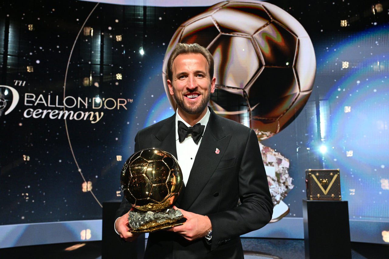 Harry Kane poses with the Ballon d’Or award (PA)
