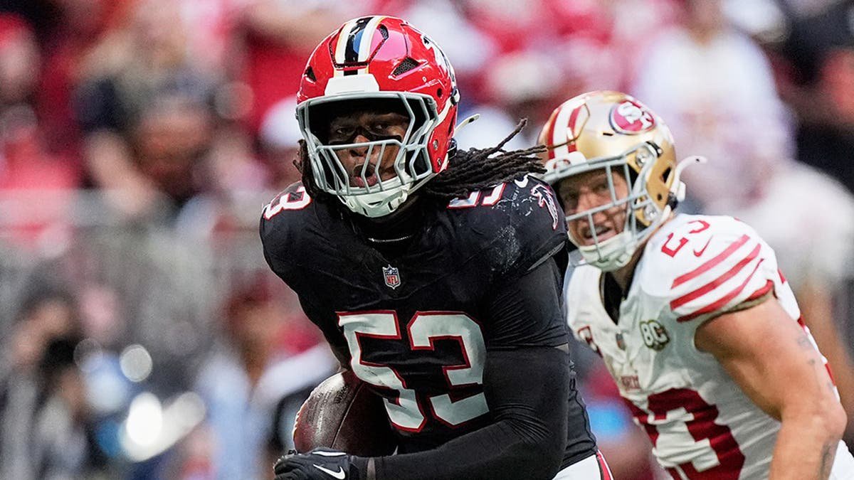 Kendal Daniels returns an interception as Christian McCaffrey and Trent Williams chase him.
