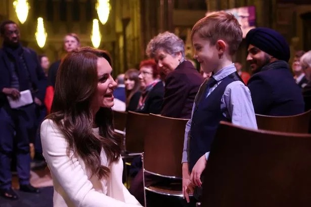 Kate speaks to a young guest at the service