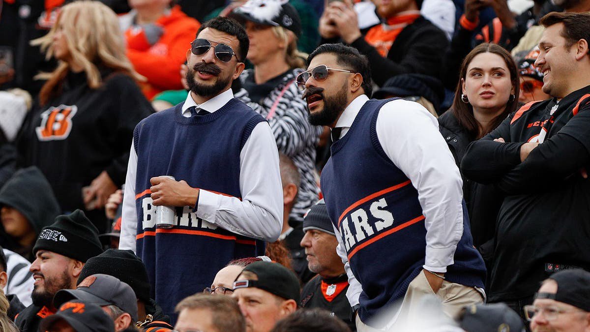 Chicago Bears fans dressed as Mike Ditka stand at Paycor Stadium.