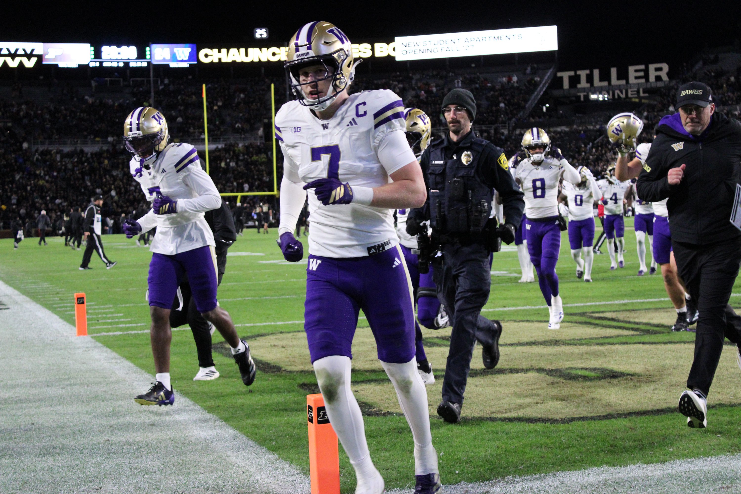 Washington Huskies safety Alex McLaughlin runs off the field at halftime during a game against the Purdue Boilermakers.