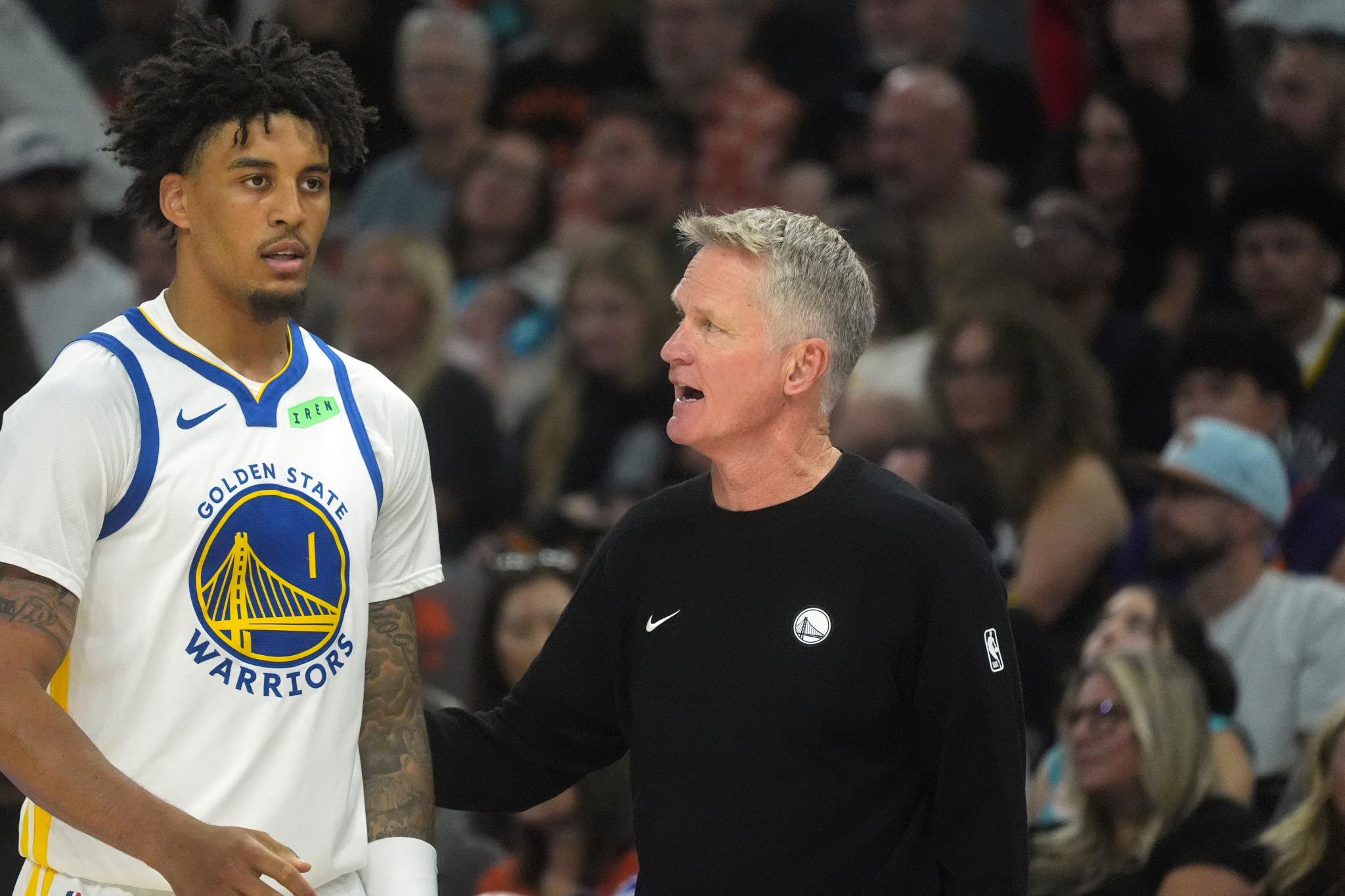 Golden State Warriors head coach Steve Kerr, right, talks with forward Yaxel Lendeborg during an NBA basketball game against the Phoenix Suns, Saturday, Oct. 24, 2026, in Phoenix.