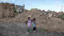 AFP Two children walk among the rubble of Sinjar