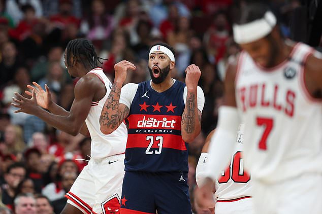 Washington Wizards forward Anthony Davis (23) reacts as Chicago Bulls forward Caleb Wilson, left, gestures and guard Buddy Hield (7) walks during the second quarter of an NBA basketball game, Saturday, Oct. 24, 2026, in Chicago. (AP Photo/Jessie Alcheh)