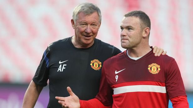 Sir Alex Ferguson (L) and Wayne Rooney of Manchester United in action during a first team training session ahead of the UEFA Champions League Group C match against Benfica at the Estadio da Luz on September 13, 2011