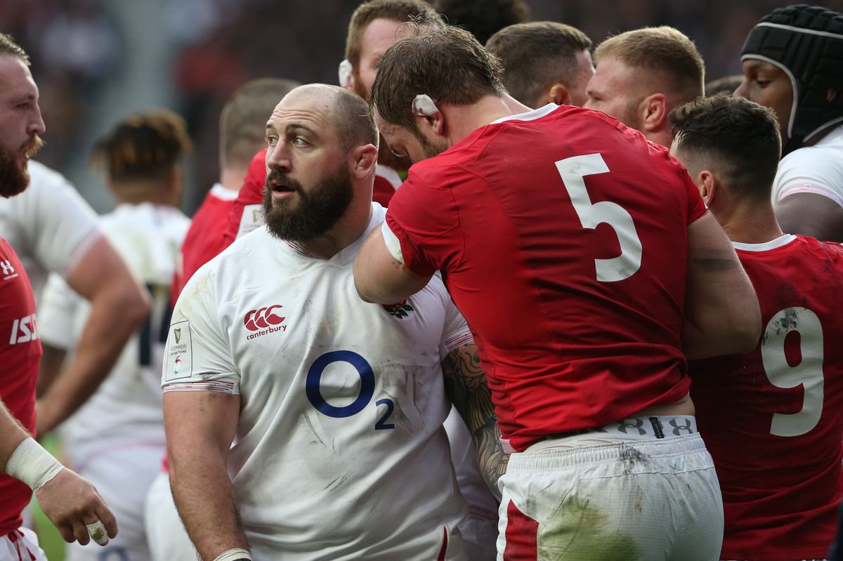 Alun Wyn-Jones of Wales looks down as Joe Marler of England grabs his crotch 