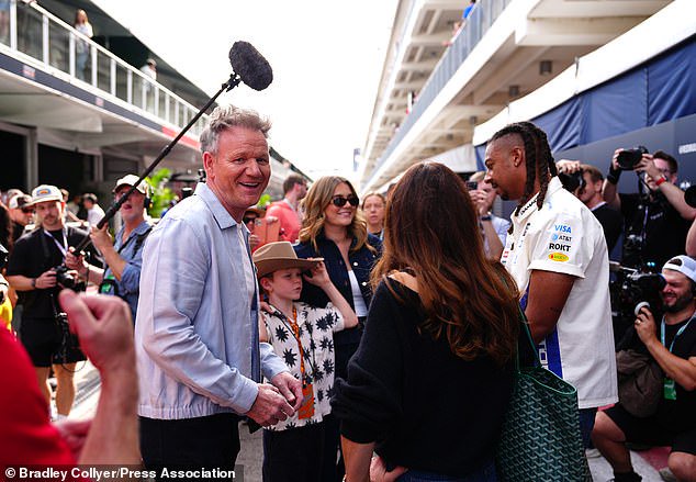 The family wore VIP badges as they walked around the paddock before the Formula One race