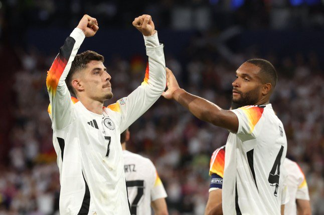 MUNICH, GERMANY - JUNE 14: Kai Havertz of Germany celebrates with teammate Jonathan Tah after scoring his team's third goal from the penalty-spot during the UEFA EURO 2024 group stage match between Germany and Scotland at Munich Football Arena on June 14, 2024 in Munich, Germany. (Photo by Alexander Hassenstein/Getty Images)