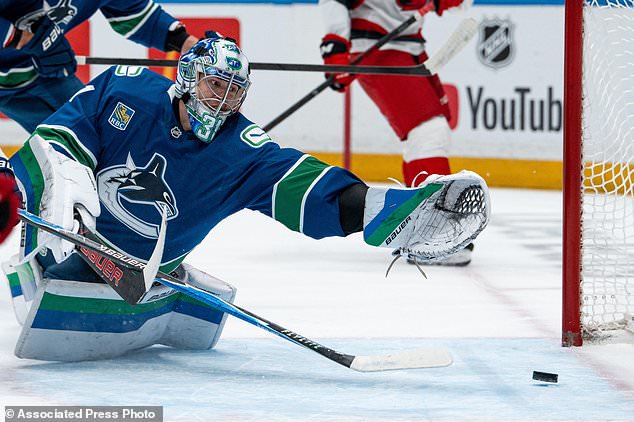 Carolina Hurricanes' Nikolaj Ehlers, not seen, scores on Vancouver Canucks goaltender Leevi Merilainen (31) during the first period of an NHL hockey game in Vancouver on Tuesday, Oct. 20, 2026. (Ethan Cairns/The Canadian Press via AP)