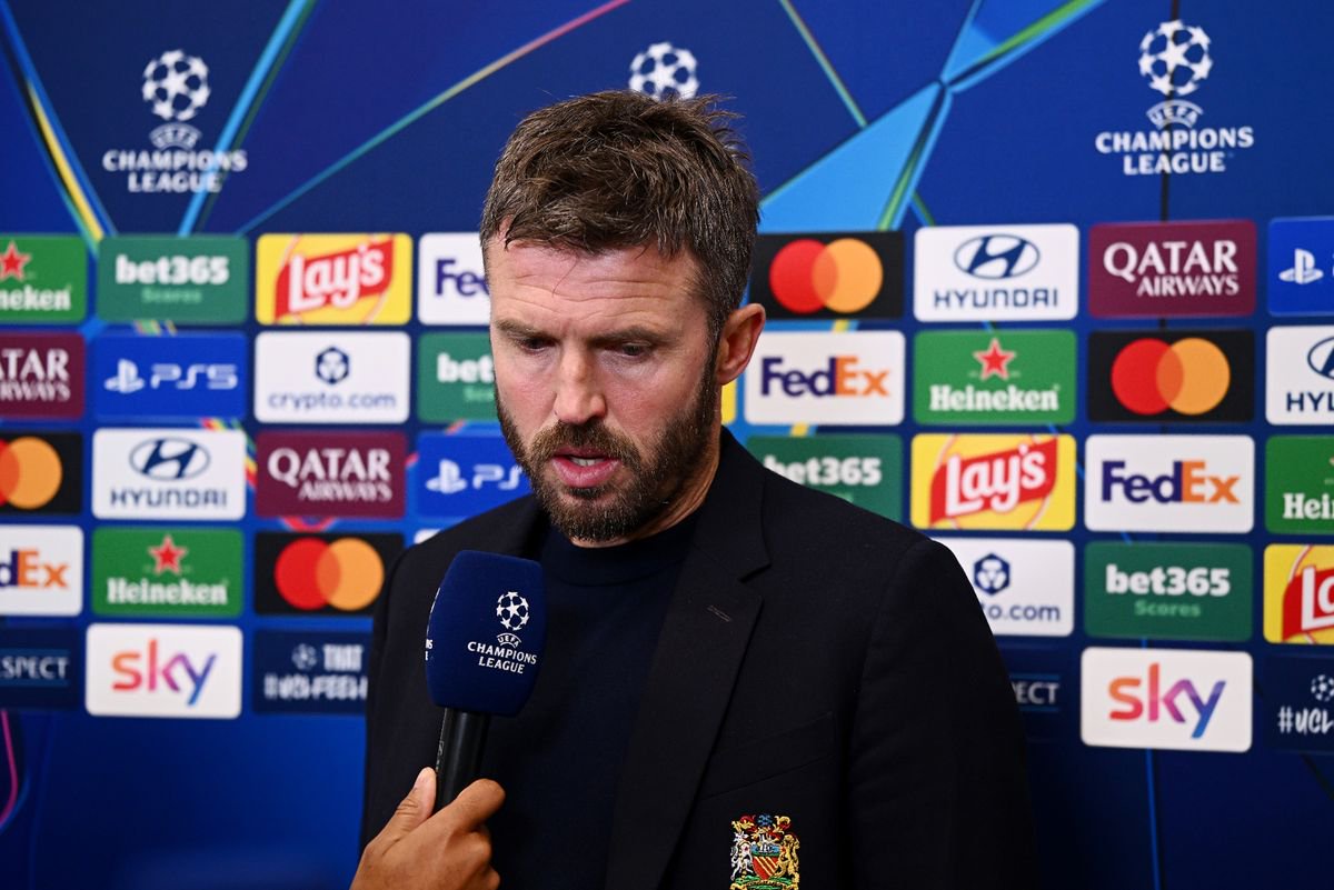 Michael Carrick speaks into a microphone