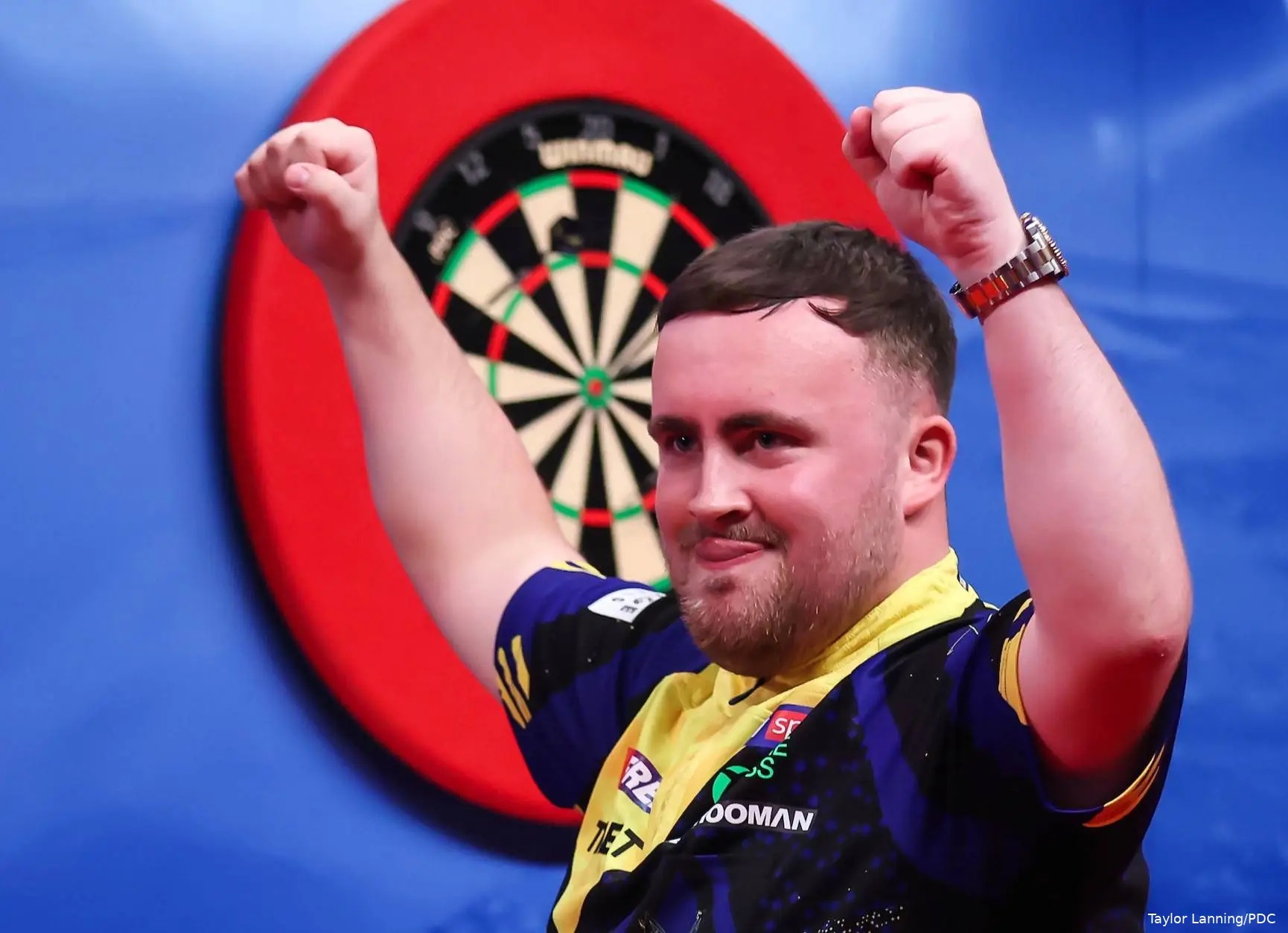 Luke Littler celebrates with clenched fists