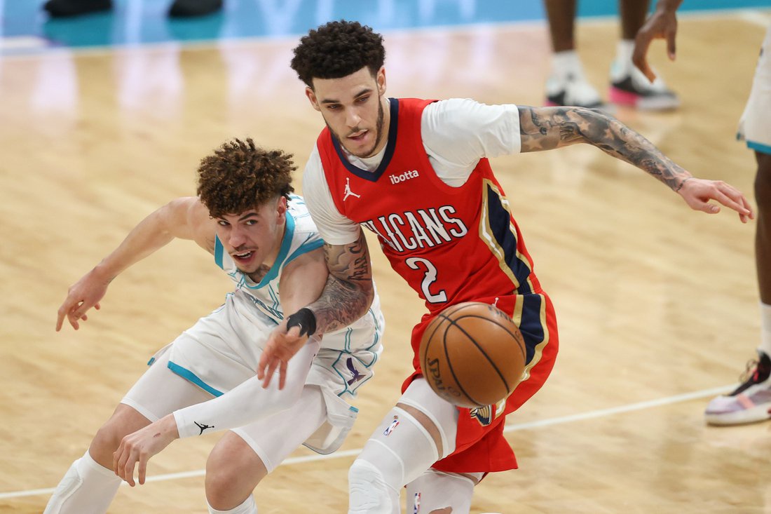 May 9, 2021; Charlotte, North Carolina, USA; Charlotte Hornets guard LaMelo Ball, left, battles New Orleans Pelicans guard Lonzo Ball (2) for a loose ball in the second half at Spectrum Center. The New Orleans Pelicans won 112-110. Mandatory Credit: Nell Redmond-USA TODAY Sports