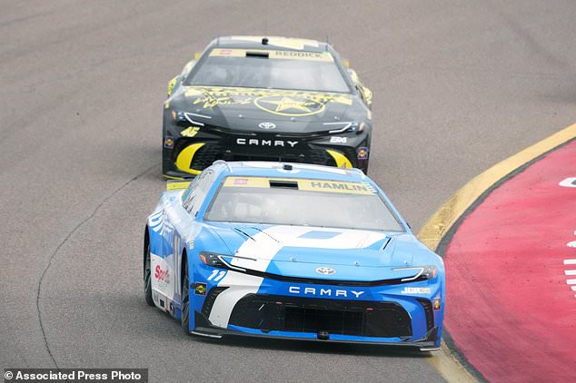 Denny Hamlin (11) leads Tyler Reddick on the 30th lap during a NASCAR Cup Series auto race Sunday, Oct. 18, 2026, in Avondale, Ariz. (AP Photo/Rick Scuteri)