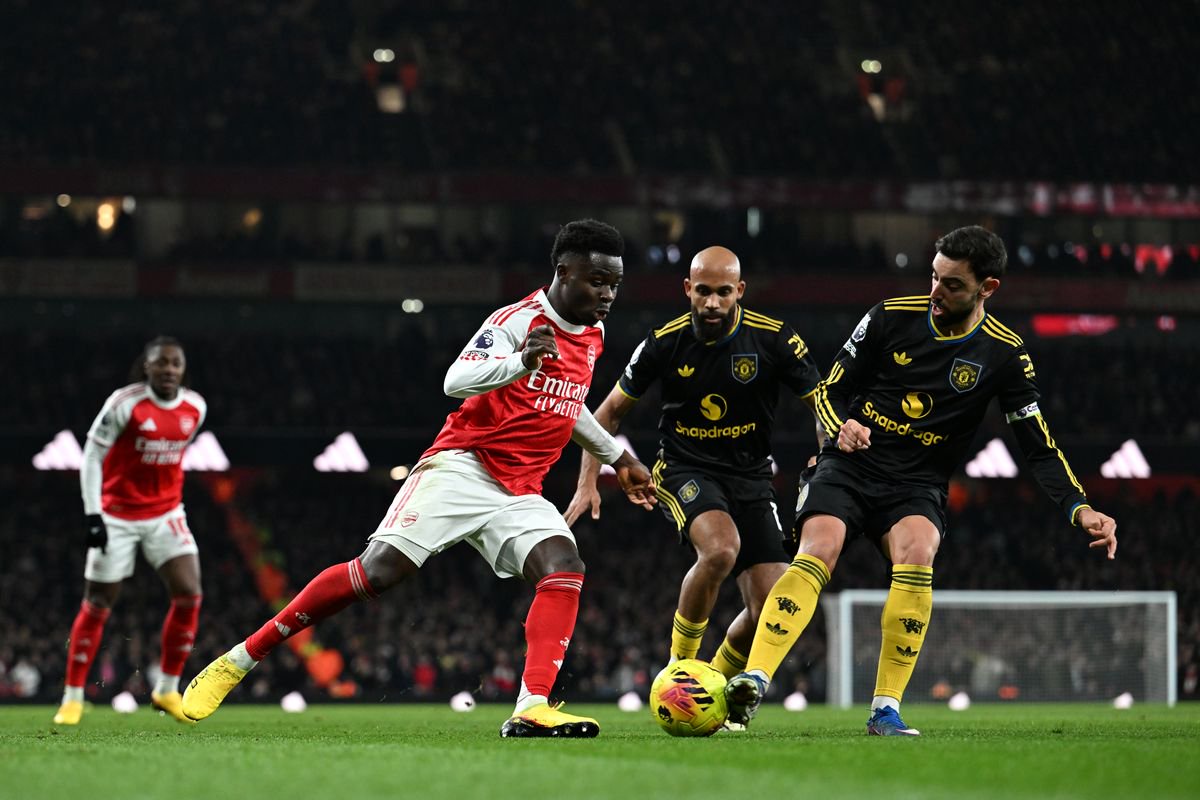 LONDON, ENGLAND - JANUARY 25: Bukayo Saka of Arsenal runs with the ball whilst under pressure from Bruno Fernandes of Manchester United during the Premier League match between Arsenal and Manchester United at Emirates Stadium on January 25, 2026 in London, England. (Photo by David Price/Arsenal FC via Getty Images)