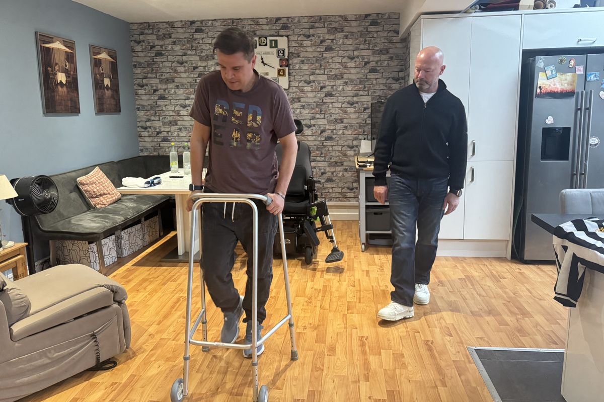 Alan Shearer takes a few steps with Keith Dungait at his home in Morpeth