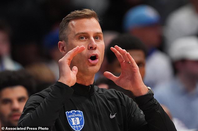 Duke's Jon Scheyer talks to his players during the first half of an exhibition NCAA college basketball game against Duke, Sunday, Oct. 25, 2026, in Lawrence, Kan. (AP Photo/Charlie Riedel)