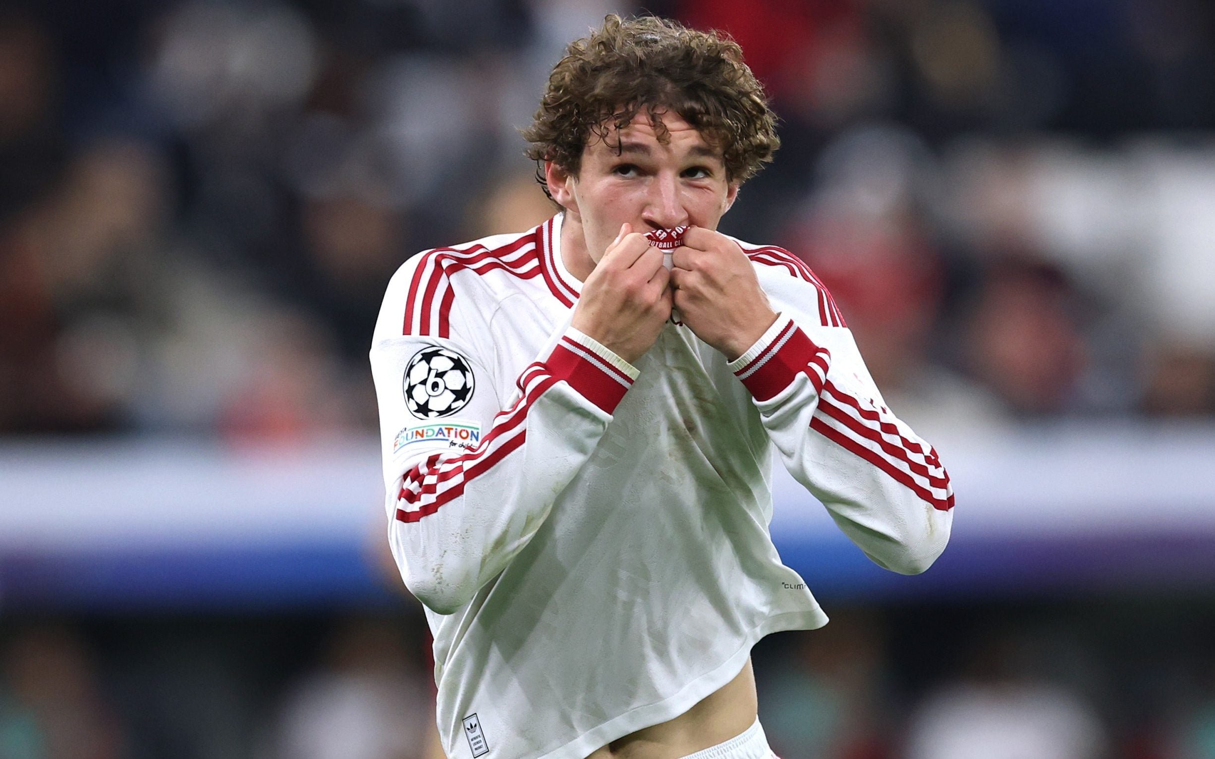 Lewis Koumas kisses the Liverpool badge