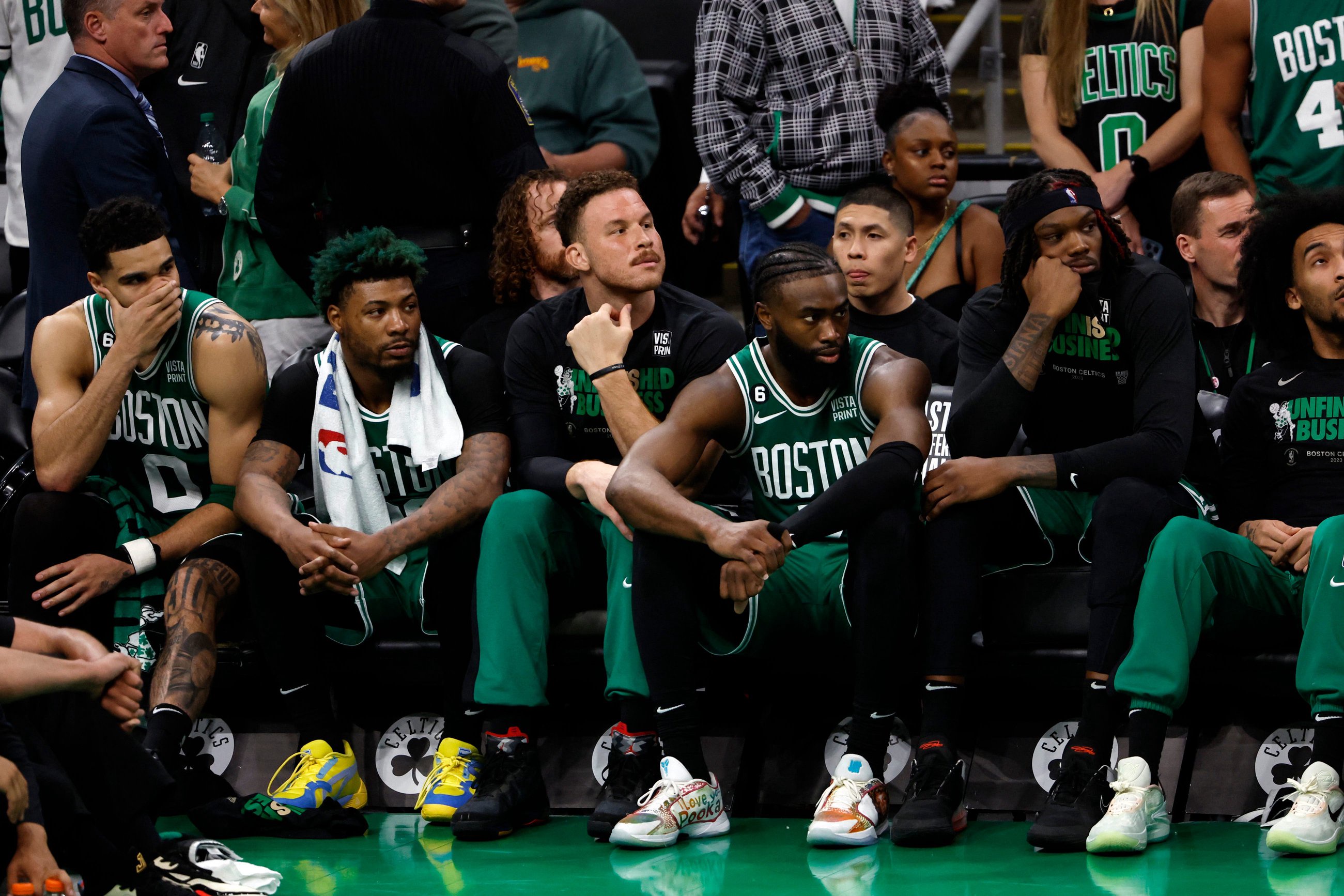 May 29, 2023; Boston, Massachusetts, USA; Boston Celtics forward Jayson Tatum (0) and guard Marcus Smart (36) and forward Blake Griffin (91) and guard Jaylen Brown (7) react from the bench during the fourth quarter against the Miami Heat in game seven of the Eastern Conference Finals for the 2023 NBA playoffs at TD Garden. Mandatory Credit: Winslow Townson-USA TODAY Sports